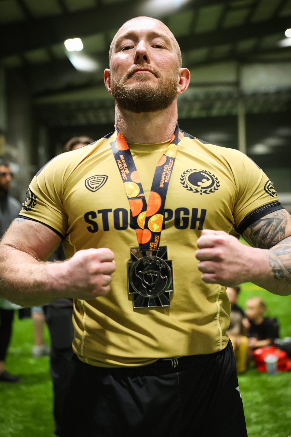 Tom K. after a jiu jitsu competition, medal around his neck